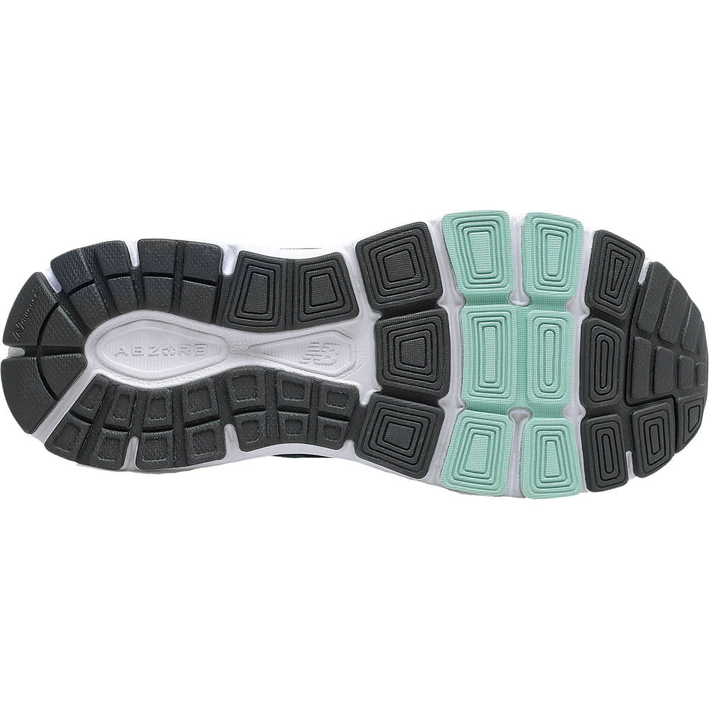 A close-up of the tread pattern on the sole of a New Balance 840v5 women&#39;s running shoe with black and mint green accents, featuring New Balance W840v5 foam cushioning.