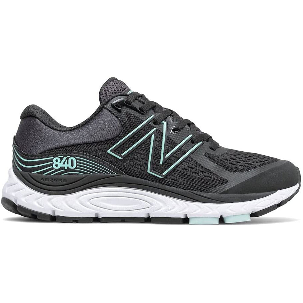 A women&#39;s New Balance 840v5 running shoe in black and mint with foam cushioning.