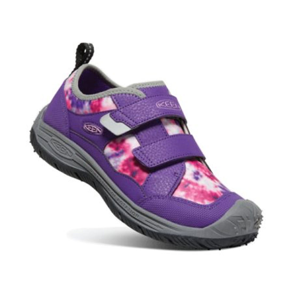 A purple and pink patterned children&#39;s Keen Speed Hound Sandal with hook and loop straps and a rubber sole.