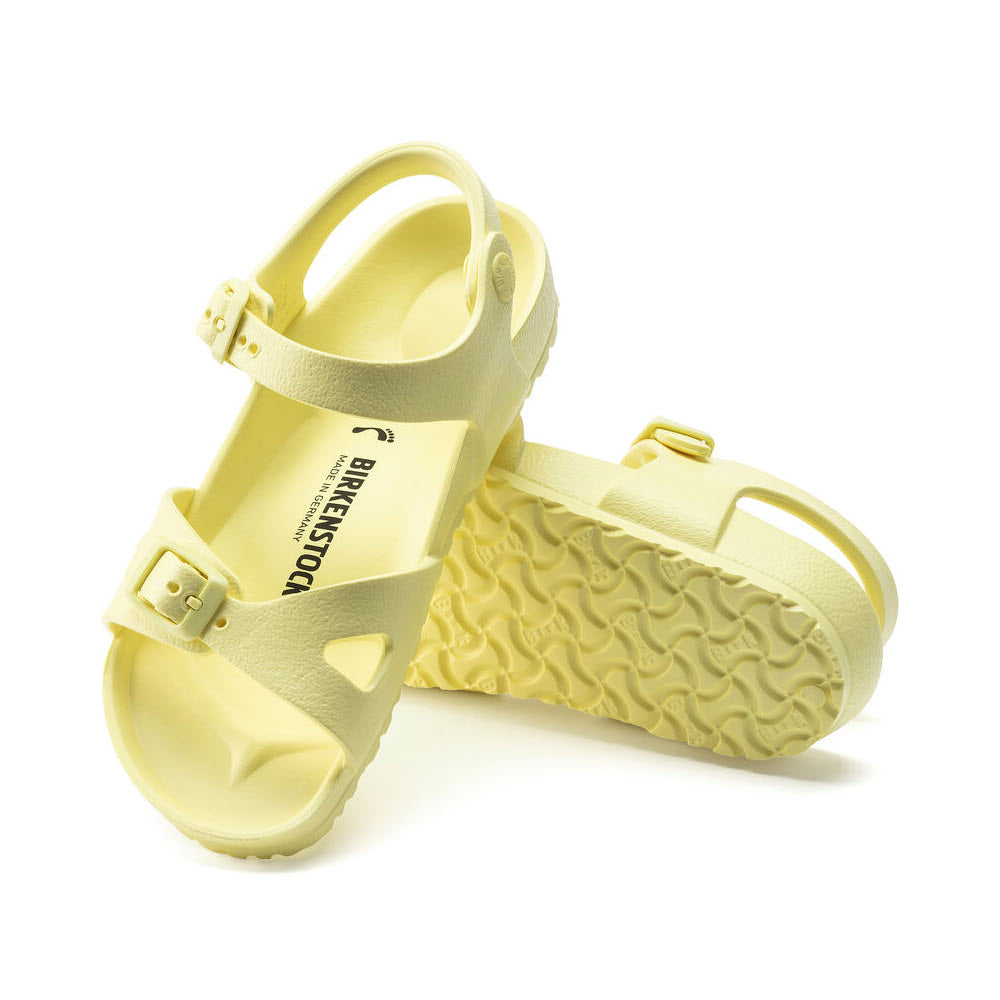 Yellow Birkenstock RIO EVA Popcorn sandals with buckle straps and textured soles.