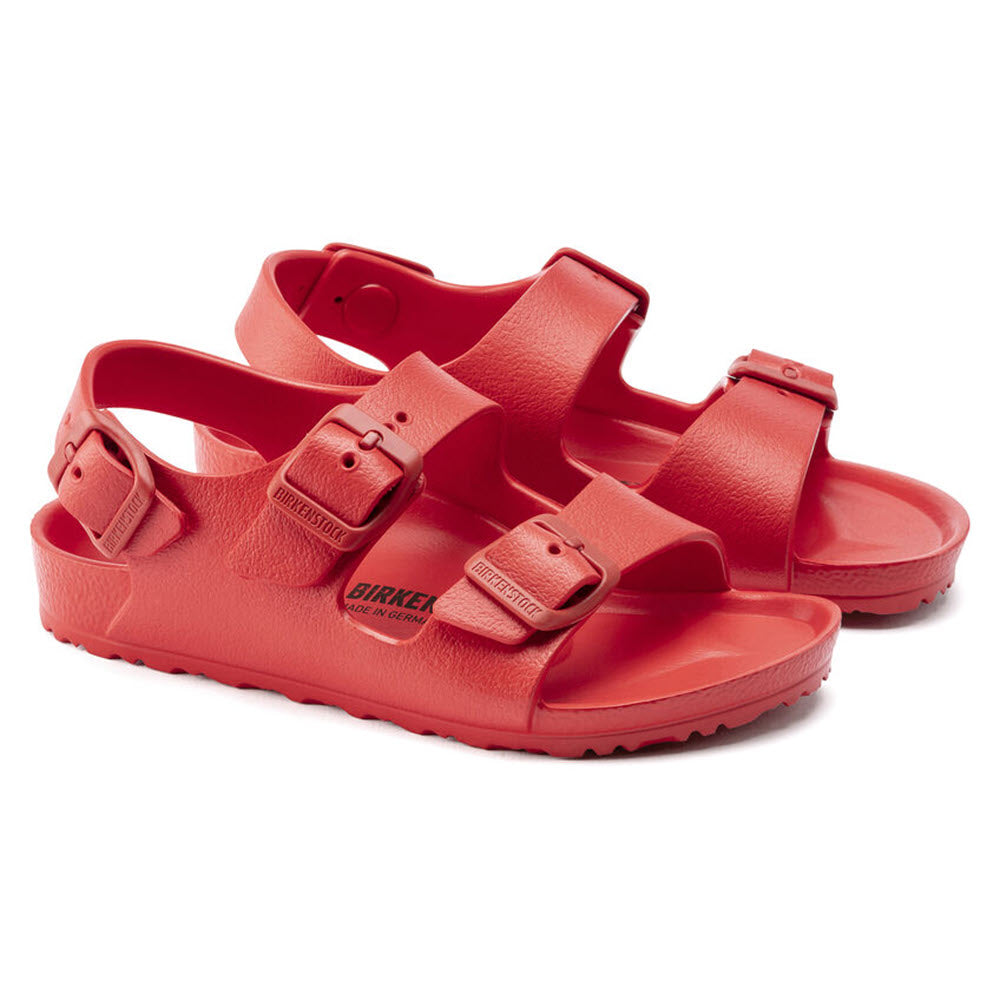 Pair of Birkenstock Milano Eva Active Red - Kids sandals with adjustable straps on a white background.