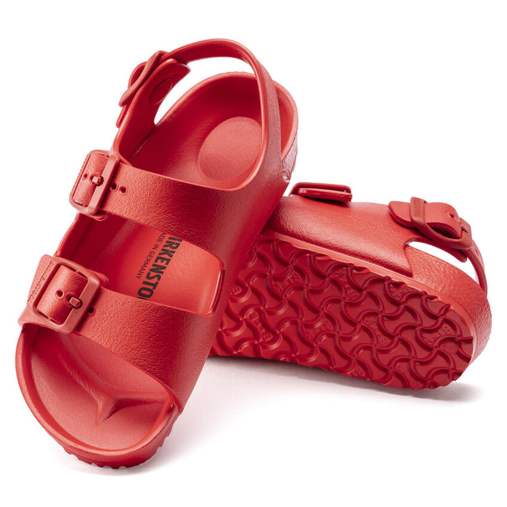 A pair of red Birkenstock Milano EVA Active Red sandals with adjustable straps and a textured sole.