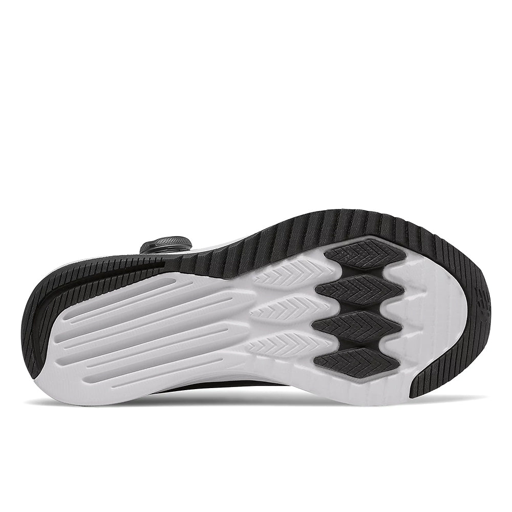 Bottom view of a modern New Balance Fuel Core Reveal BOA Black/White - Kids sneaker showcasing its tread pattern.