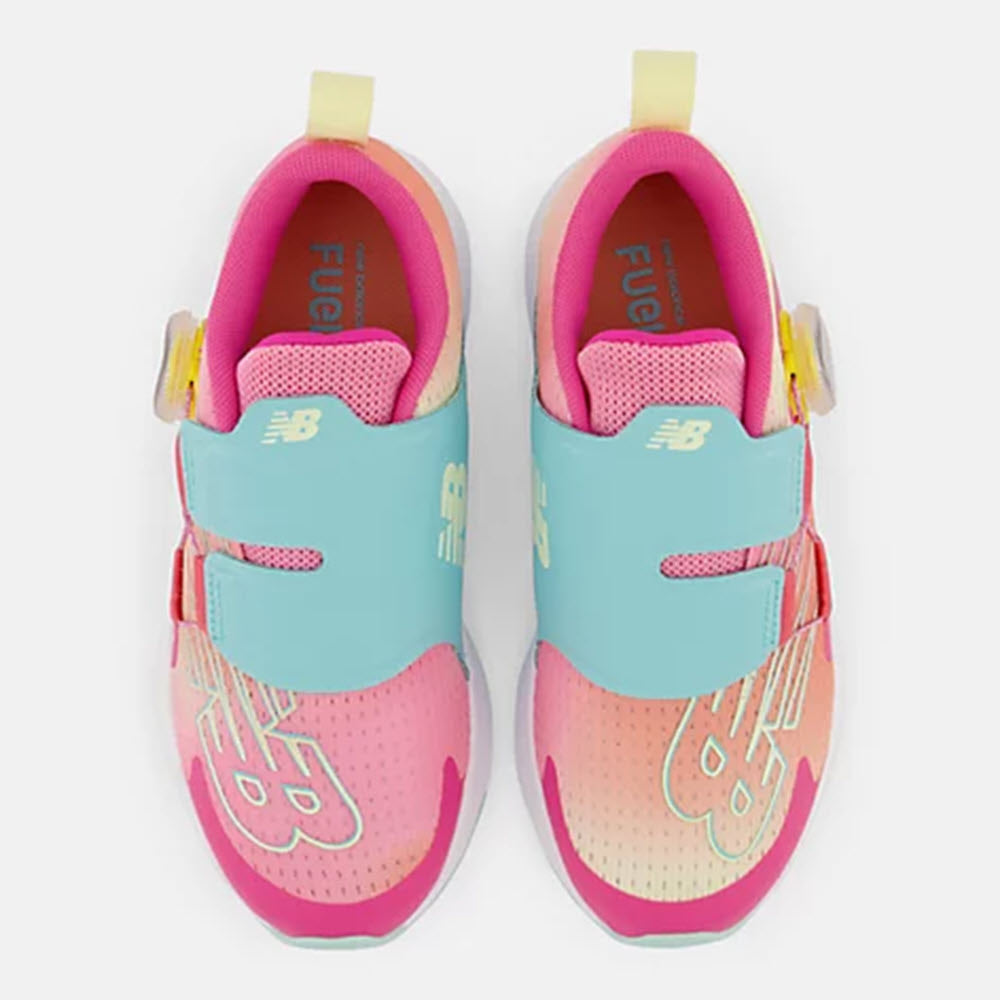 A pair of colorful New Balance FUEL CORE REVEAL BOA HI-PINK/SURF kids&#39; running shoes with hook and loop closures and REVlite cushioning.