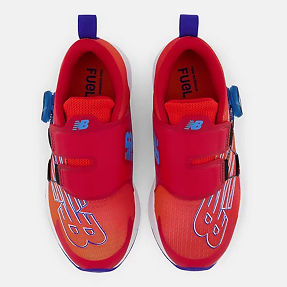 A pair of New Balance FuelCore Reveal Neo Flame - Kids running shoes with a red and orange design, featuring a hook-and-loop closure.