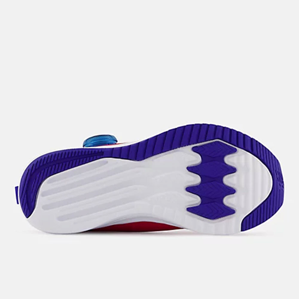 Sole of a New Balance sneaker with white, purple, and blue elements, featuring REVlite midsole technology.