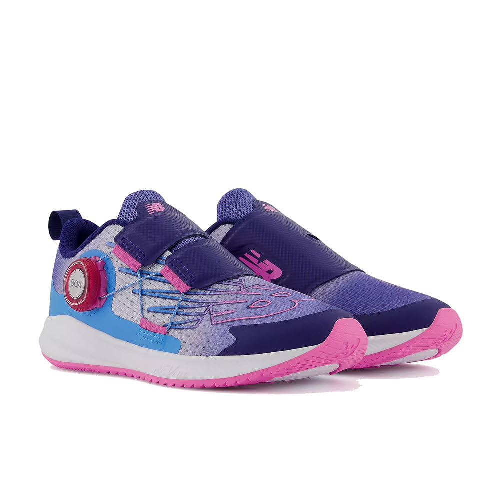 A pair of purple and pink New Balance FuelCore Reveal BOA Vibrant Violet children&#39;s athletic shoes.