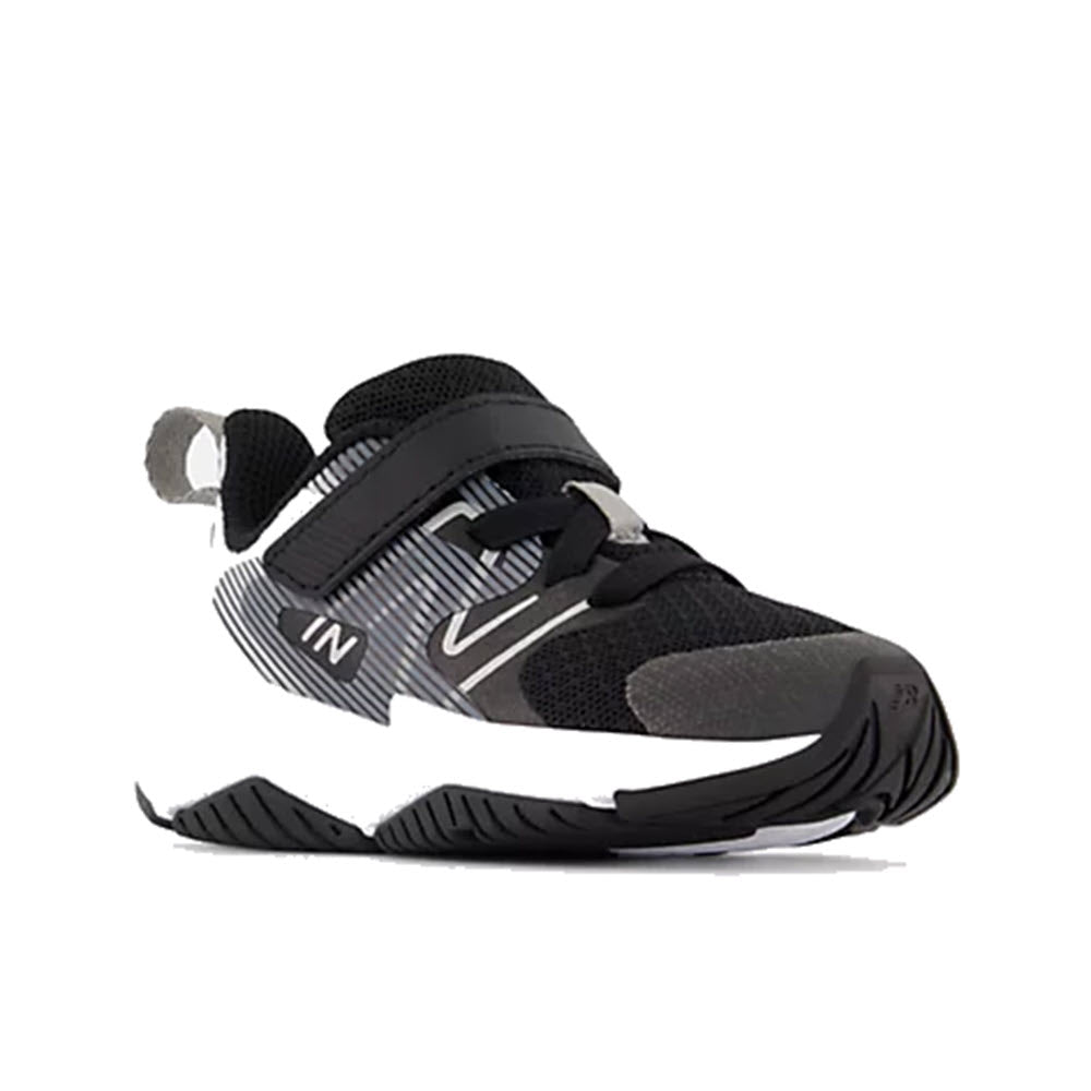 A modern New Balance Rave Run V2 Black/White - Infant kids’ running shoe with a unique strap design and a prominent logo on the side.