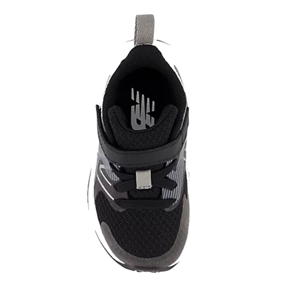 Top view of a New Balance Rave Run V2 black kids’ running shoe with a velcro strap.
