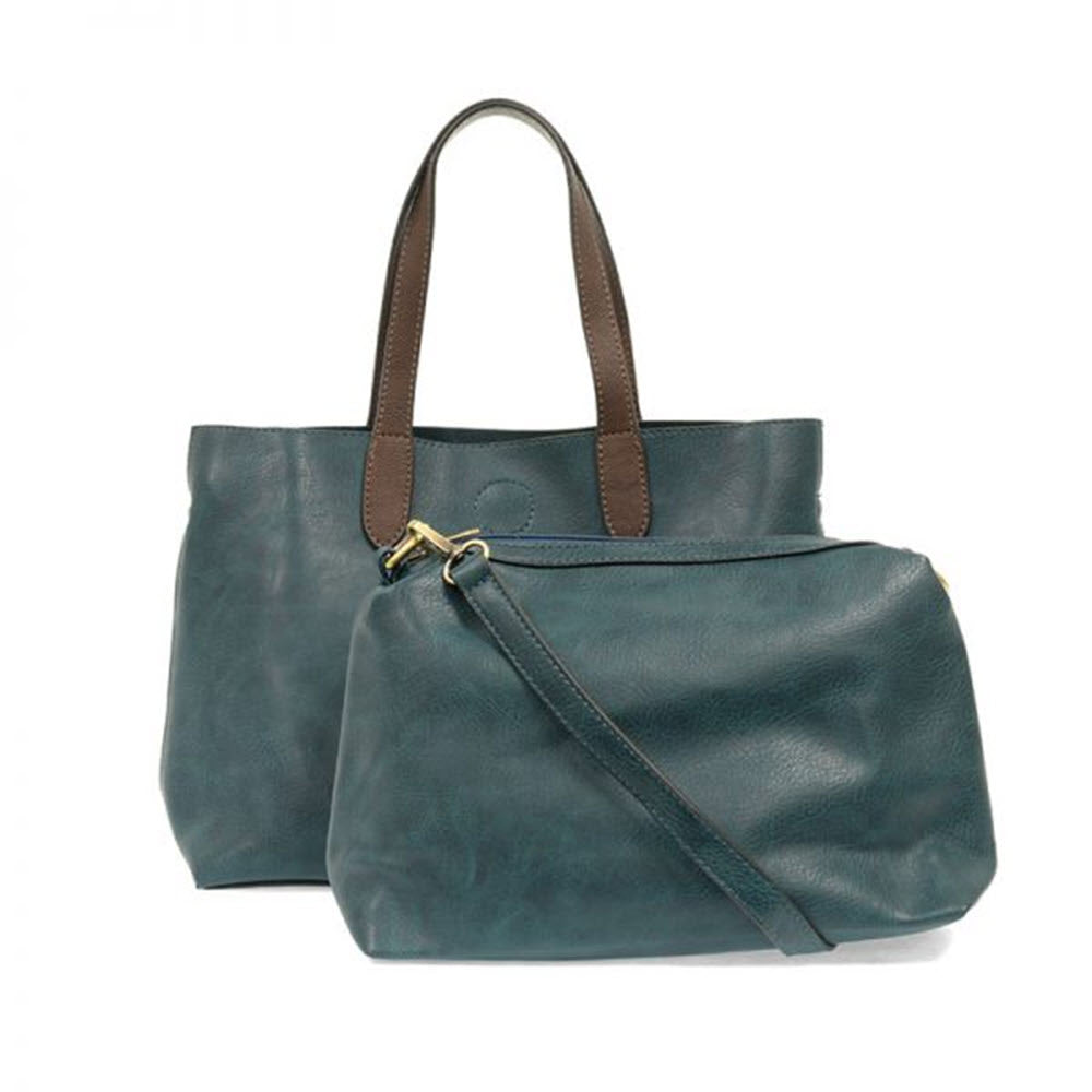 Two Joy Susan New Mariah Tote Bags in Dark Turquoise with brown handles isolated on a white background.