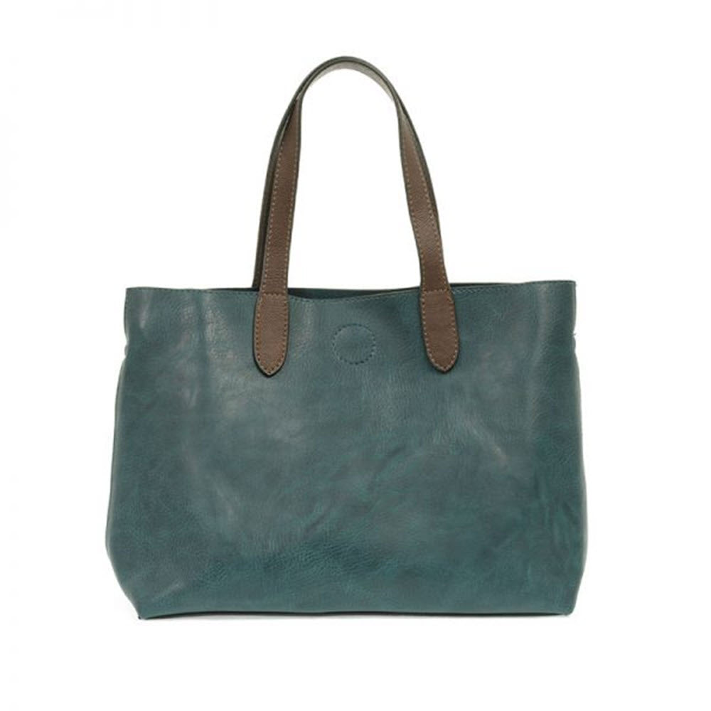 A teal vegan leather JOY SUSAN NEW MARIAH TOTE BAGE DARK TURQUOISE crossbody bag with brown handles on a white background.