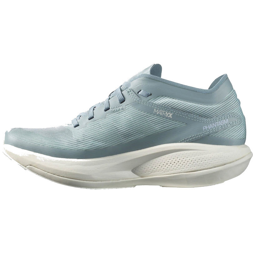 A single light blue Salomon Phantasm Trooper/Lunar Rock women&#39;s athletic running shoe with white sole displayed against a white background.