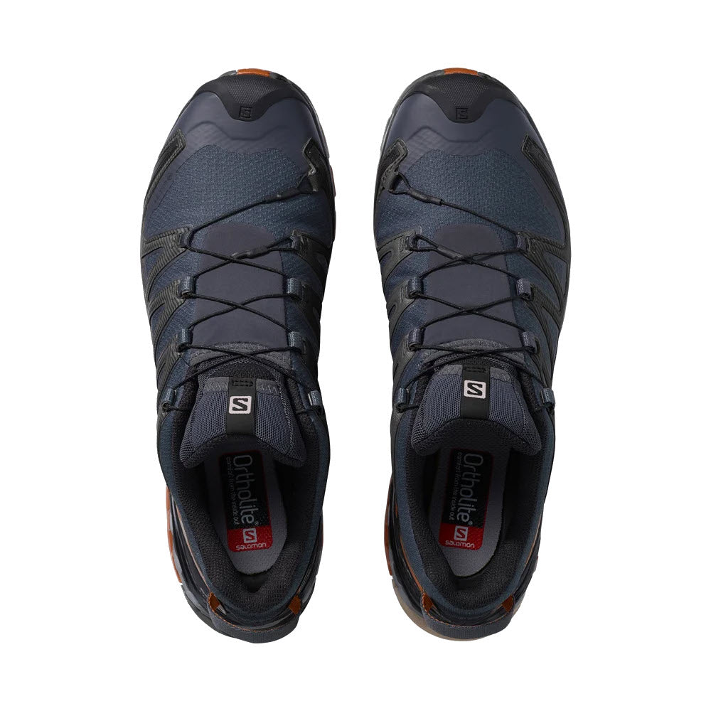 A pair of Salomon SALOMON XA PRO 3DV8 GTX EBONY/CARAMEL CAFE/BLACK hiking shoes with navy blue and black colors, viewed from above, isolated on a white background.