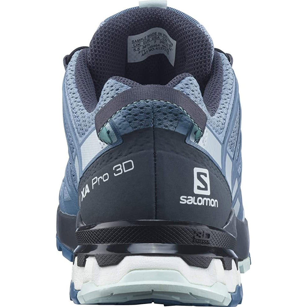 Rear view of a Salomon hiking shoe showing the heel, branded with &quot;Salomon&quot; and &quot;SALOMON XA PRO 3D V8 BLUE/EBONY - WOMENS,&quot; in blue and gray tones.