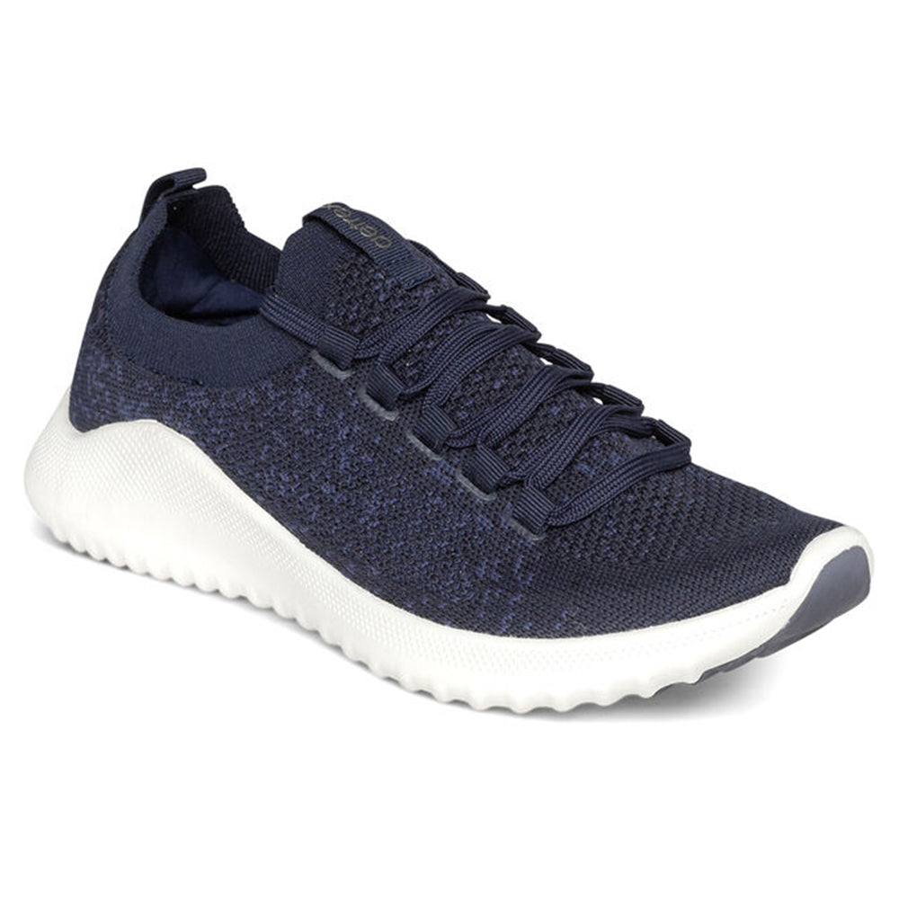 A single Aetrex Carly Navy athletic sneaker with white sole, arch support, and lace-up closure, designed as a women&#39;s casual shoe.