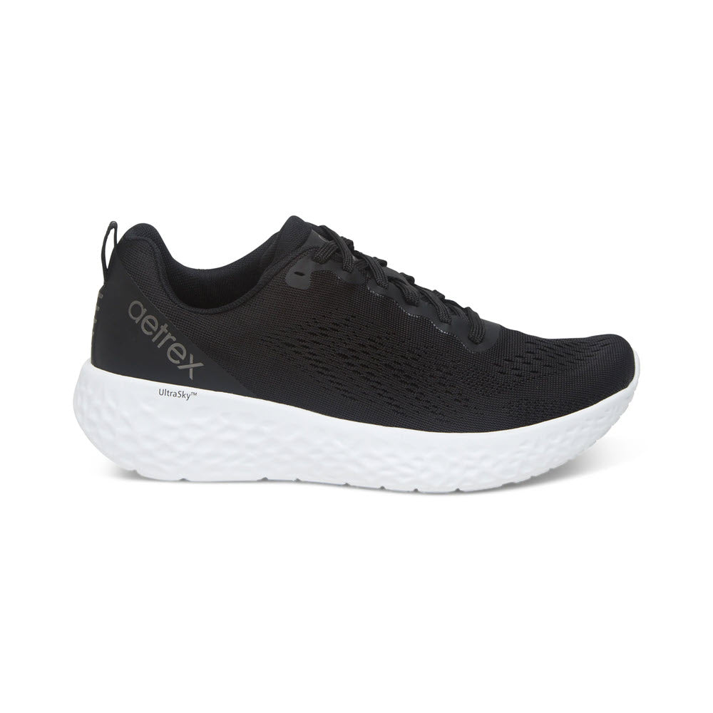 A single black Aetrex Danika running shoe with a white sole on a white background.