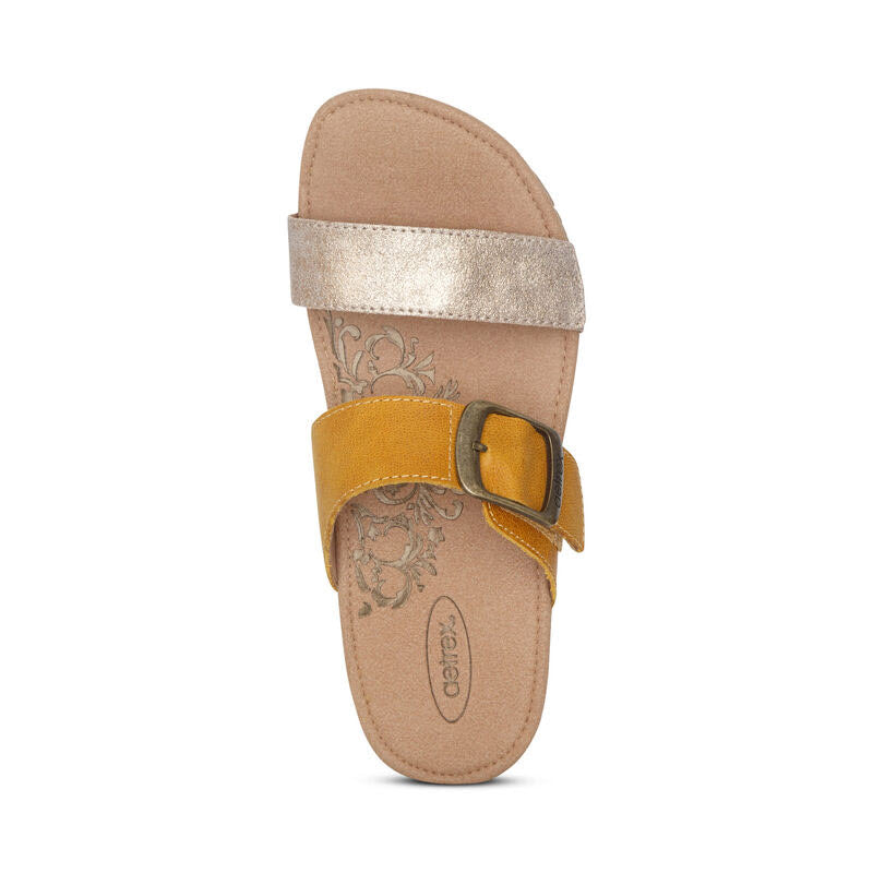 Women&#39;s Aetrex Daisy Sunflower sandal with a metallic gold strap, adjustable straps, and a tan sole.