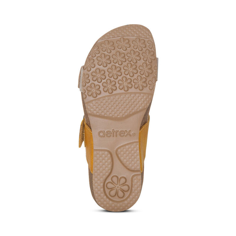 Aetrex brown leather sandals with patterned sole and yellow straps displaying the Aetrex brand logo, featuring arch support.
