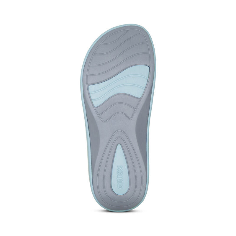 Sole of a Aetrex Maui New Blue - Womens shoe with a gray tread design, extreme cushioning, and brand logo.