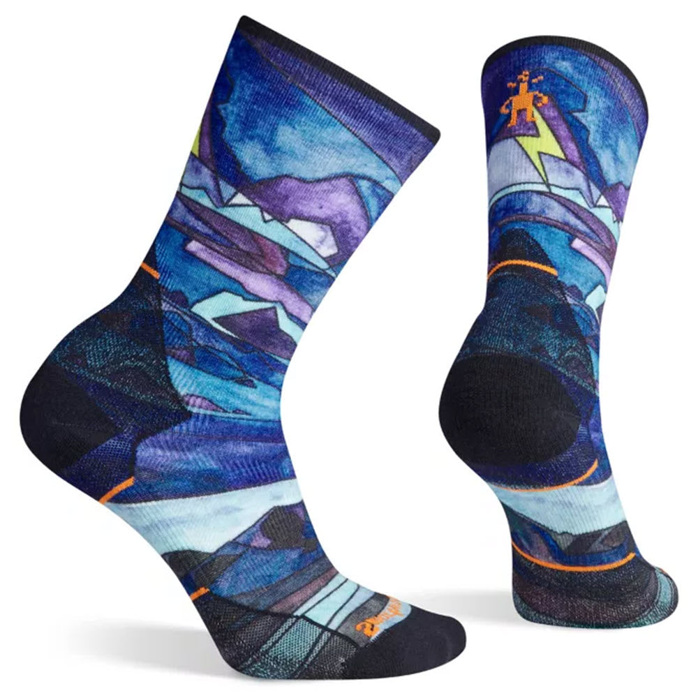 Smartwool women&#39;s running socks with a colorful mountain landscape design and a hiker motif.