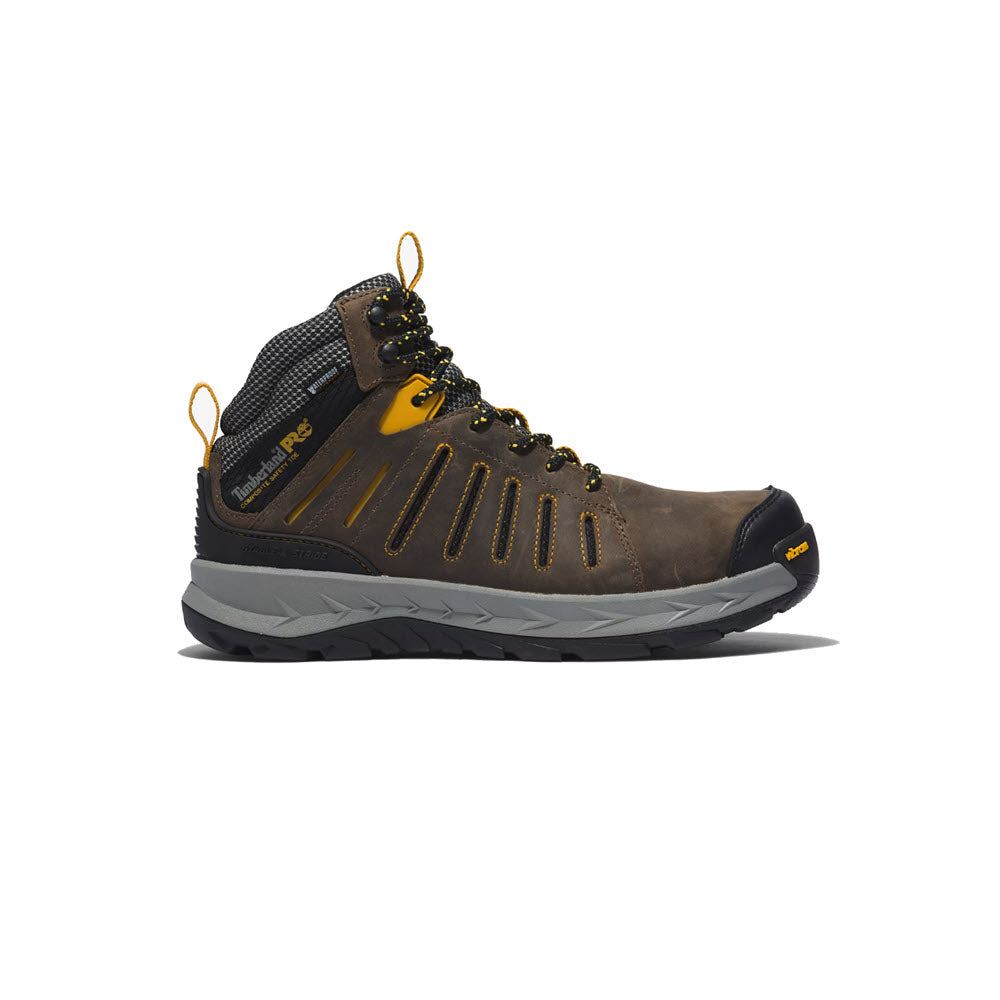 Men&#39;s brown and gray Timberland PRO Trailwind Comp Toe WP hiking boot with yellow laces on a white background.