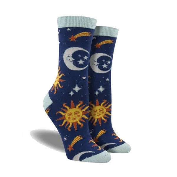 A pair of Socksmith certified organic socks with a celestial design, featuring moons, suns, and stars on a navy blue background.