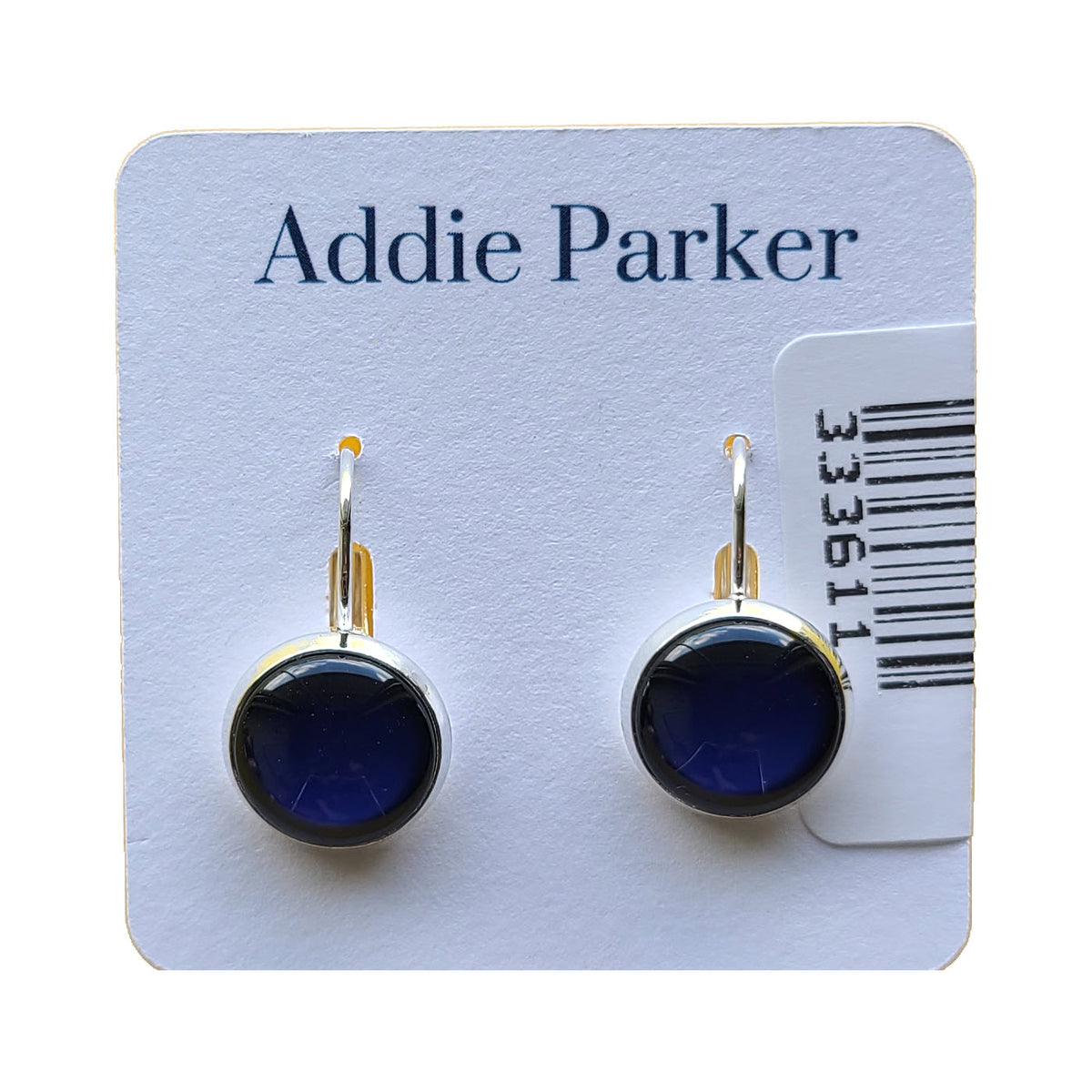 A pair of round navy solid Addie Parker earrings mounted on a white Addie Parker jewelry card.