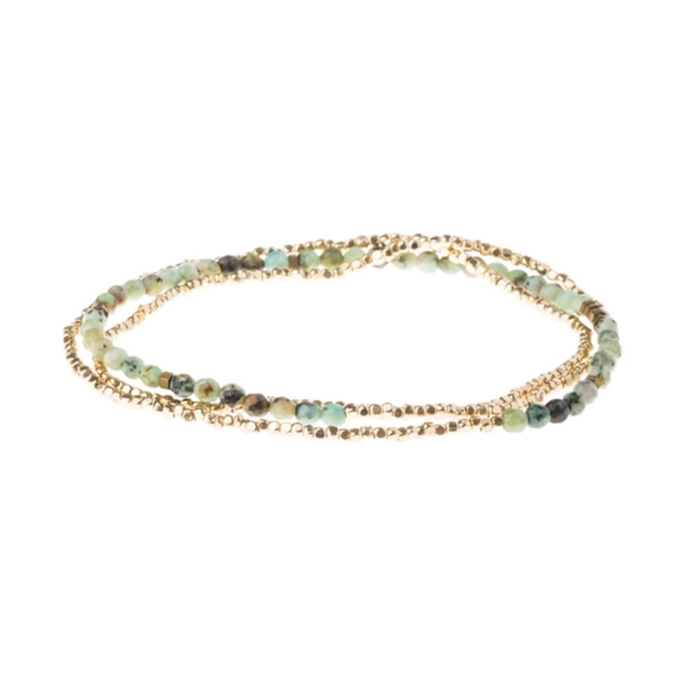 Scout beaded bracelet with SCOUT DELICATE STONE WRAP BRACELET TURQUOISE and green hues, including semi-precious gemstone beads and gold-tone accents, on a white background.