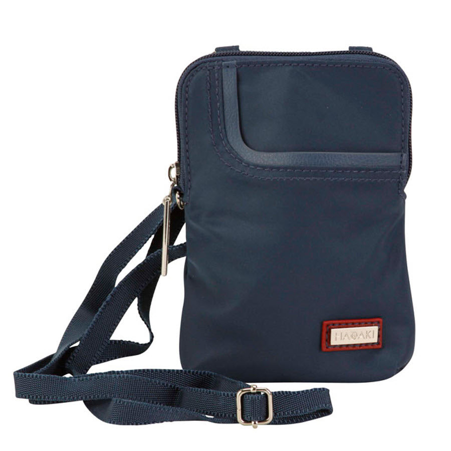 Navy blue Hadaki Mobile crossbody bag teal with adjustable strap and brand label, perfect for travel light with small accessories.
