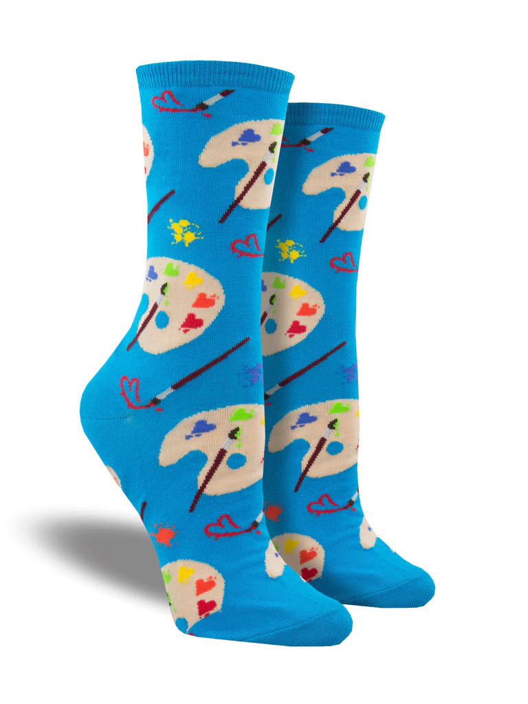 A pair of SOCKSMITH LOVELY ART SOCKS BLUE with artist palette and paintbrush pattern on a white background.