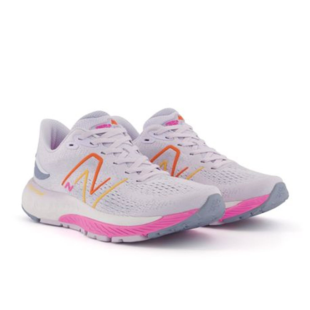 A pair of New Balance 880v12 Libra/Pink/Orange running shoes in gray with orange logos and pink accents, displayed against a white background.