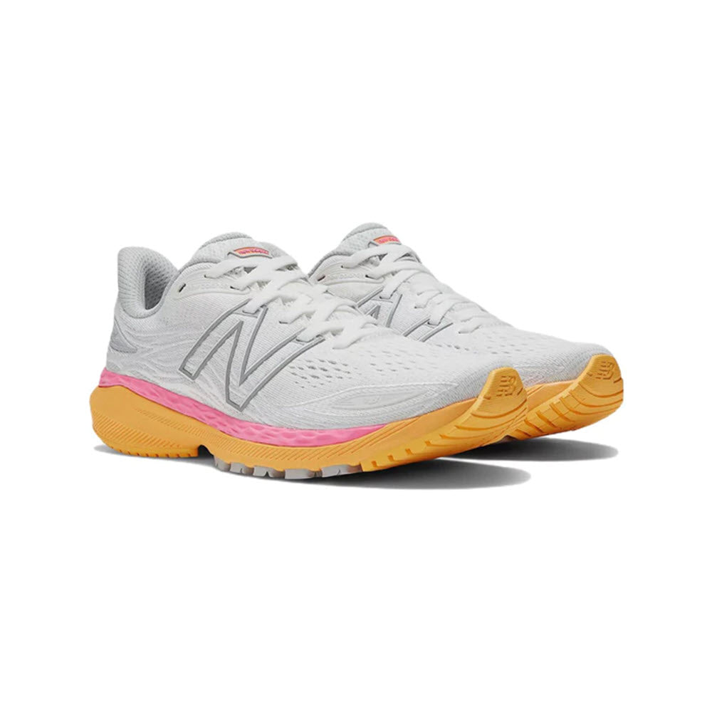 A pair of New Balance 860v12 stability running shoes in white with a pink stripe and yellow soles, viewed from the side.