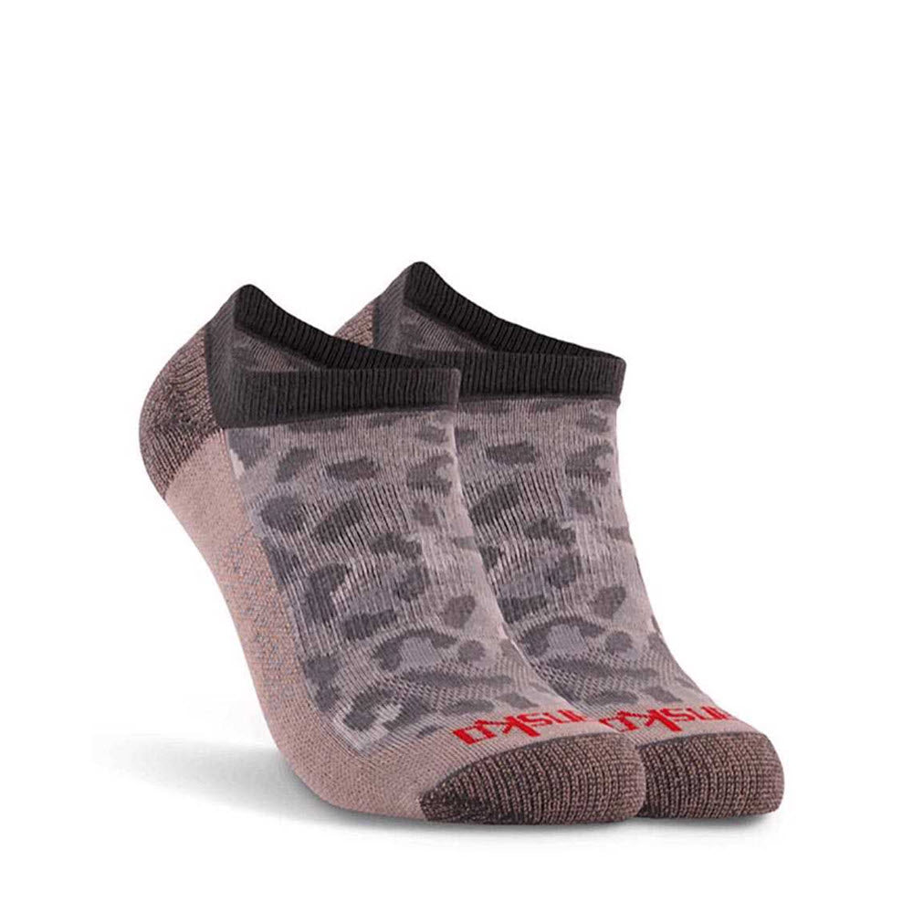 A pair of ankle-high, odor-resistant DANSKO CHEETAH LOW CUT SOCKS SNOW with a camouflage pattern and visible Dansko brand name on the sole.
