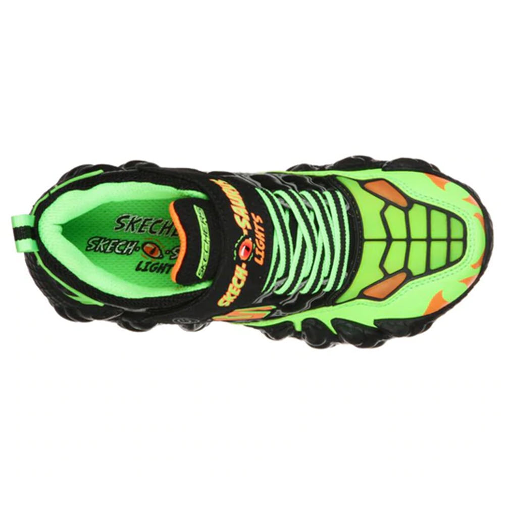A colorful children&#39;s Skechers SKECH-O-SAURUS Lights sneaker with black, lime, and orange accents featuring a dinosaur-inspired design and light-up sole.