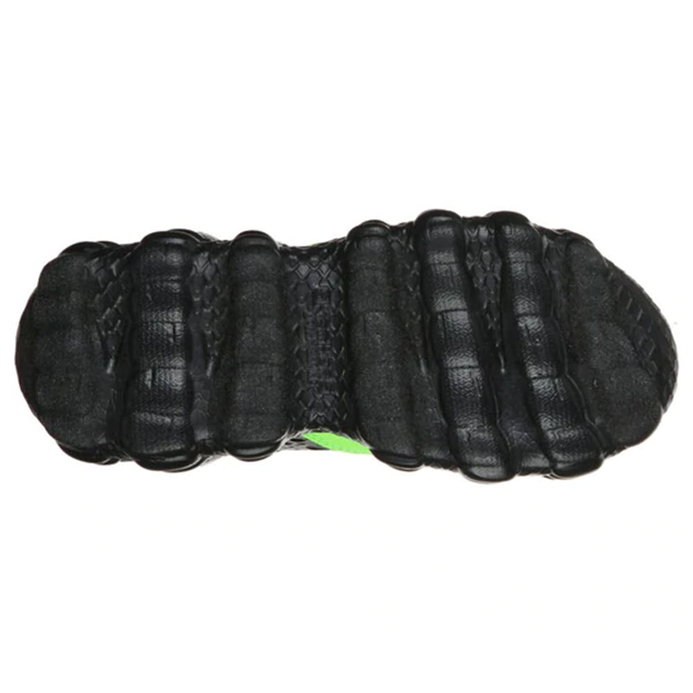Skechers SKECH-O-SAURUS Lights black sports shoe sole with green detail and dinosaur-inspired design.