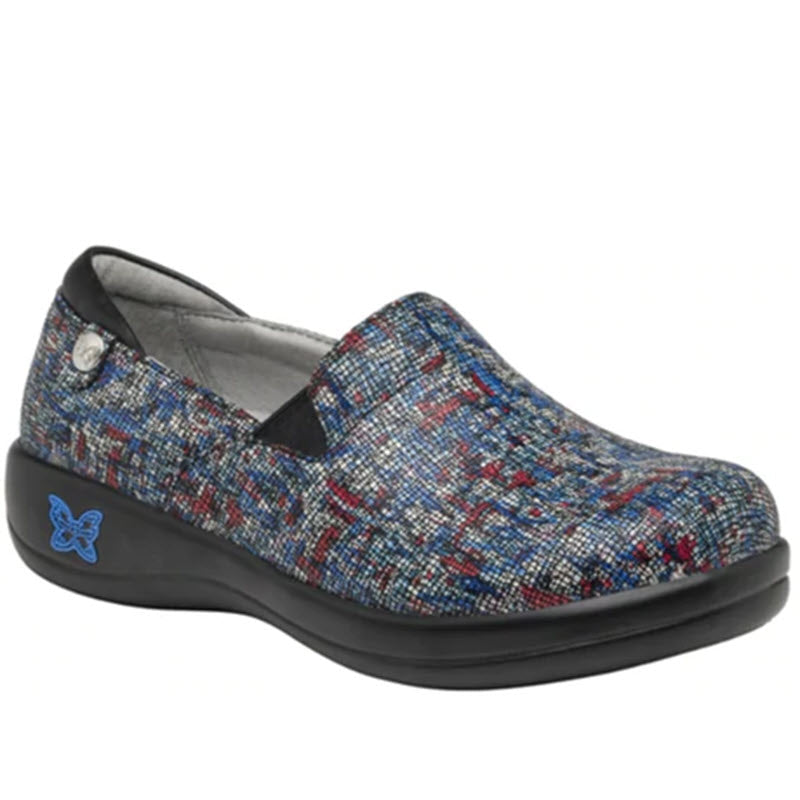 Women&#39;s Alegria Keli The Whole Shebang slip-on shoe with a cushioned sole and a decorative blue butterfly emblem on the side.