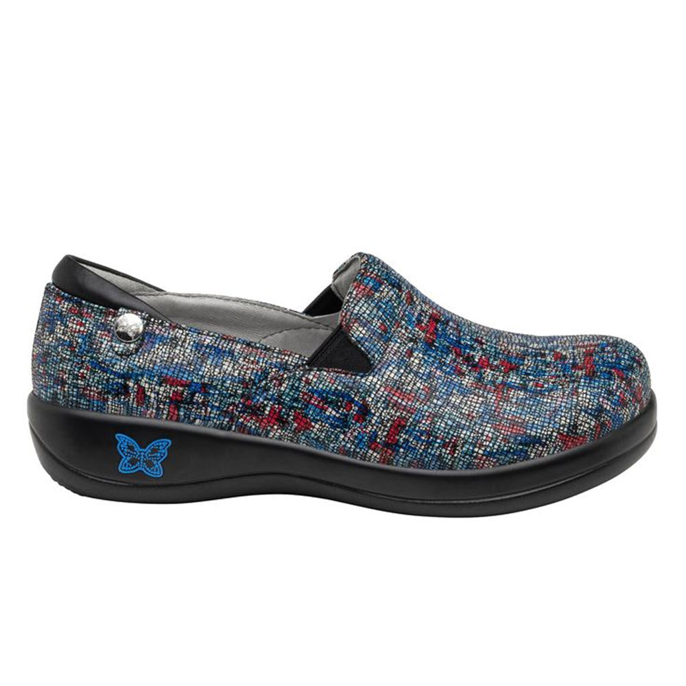A colorful, patterned ALEGRIA KELI THE WHOLE SHEBANG clog shoe with a butterfly emblem on it, designed for nurses with its slip-resistant feature.