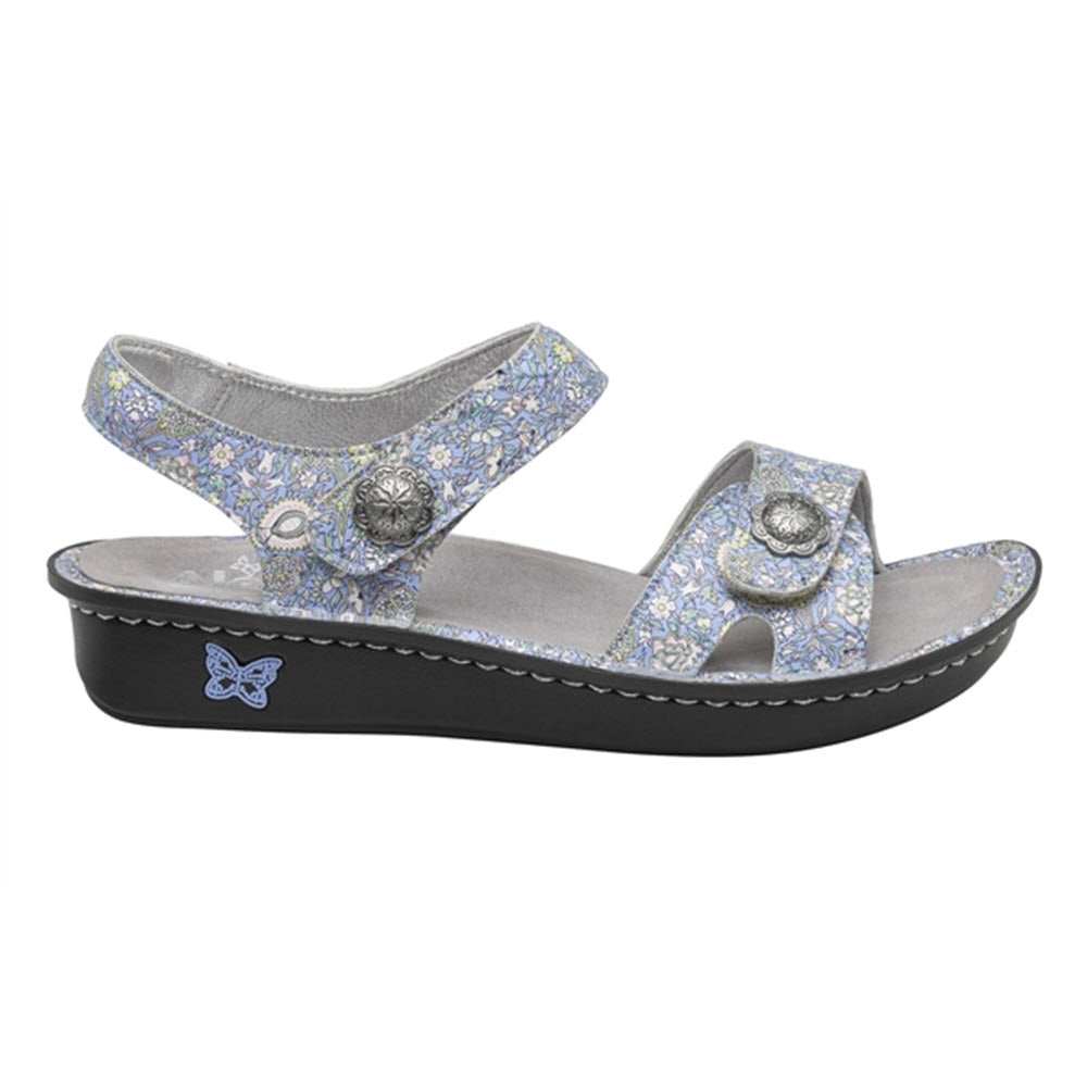 A pair of Alegria Vienna Smooth Jazz women&#39;s wedge sandals with adjustable hook-and-loop closures and decorative metal accents.