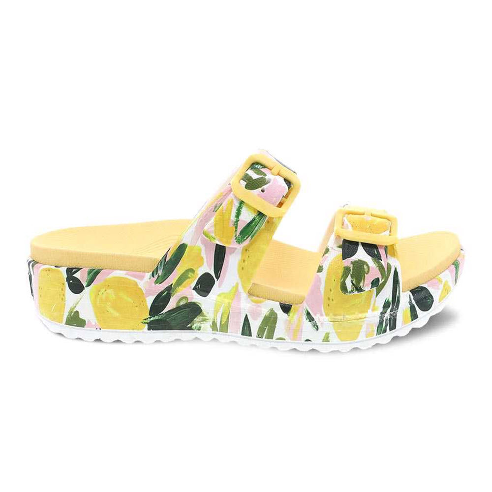 Yellow floral-patterned Dansko Kandi Lemons summer sandal with adjustable strap on a white background.