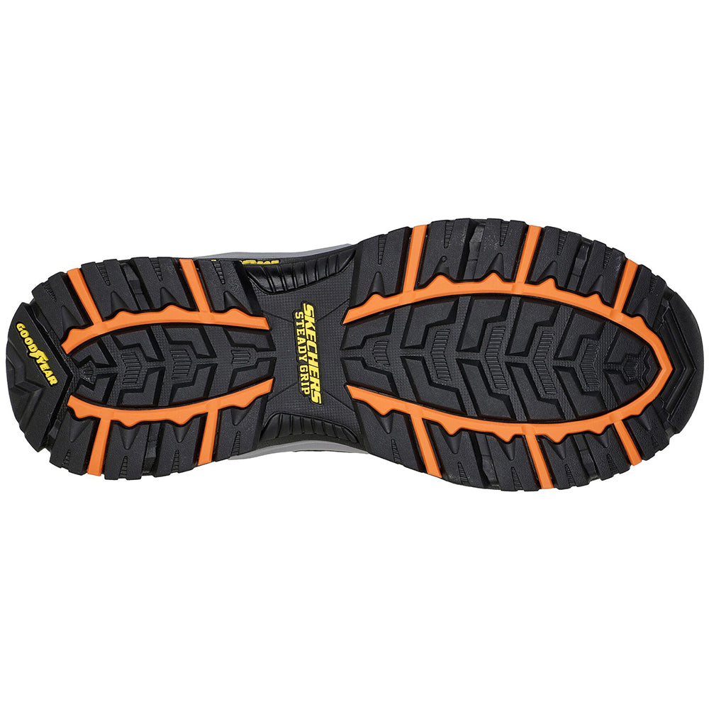 Bottom view of a pair of Skechers Vortego Arch Fit athletic shoes showcasing the black and orange tread pattern.