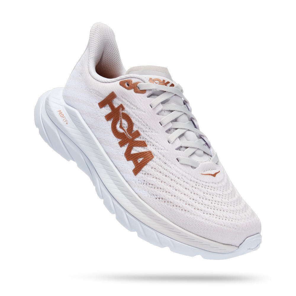 A single white HOKA ONE ONE MACH 5 running shoe with orange branding and a rubberized EVA sole on a white background.