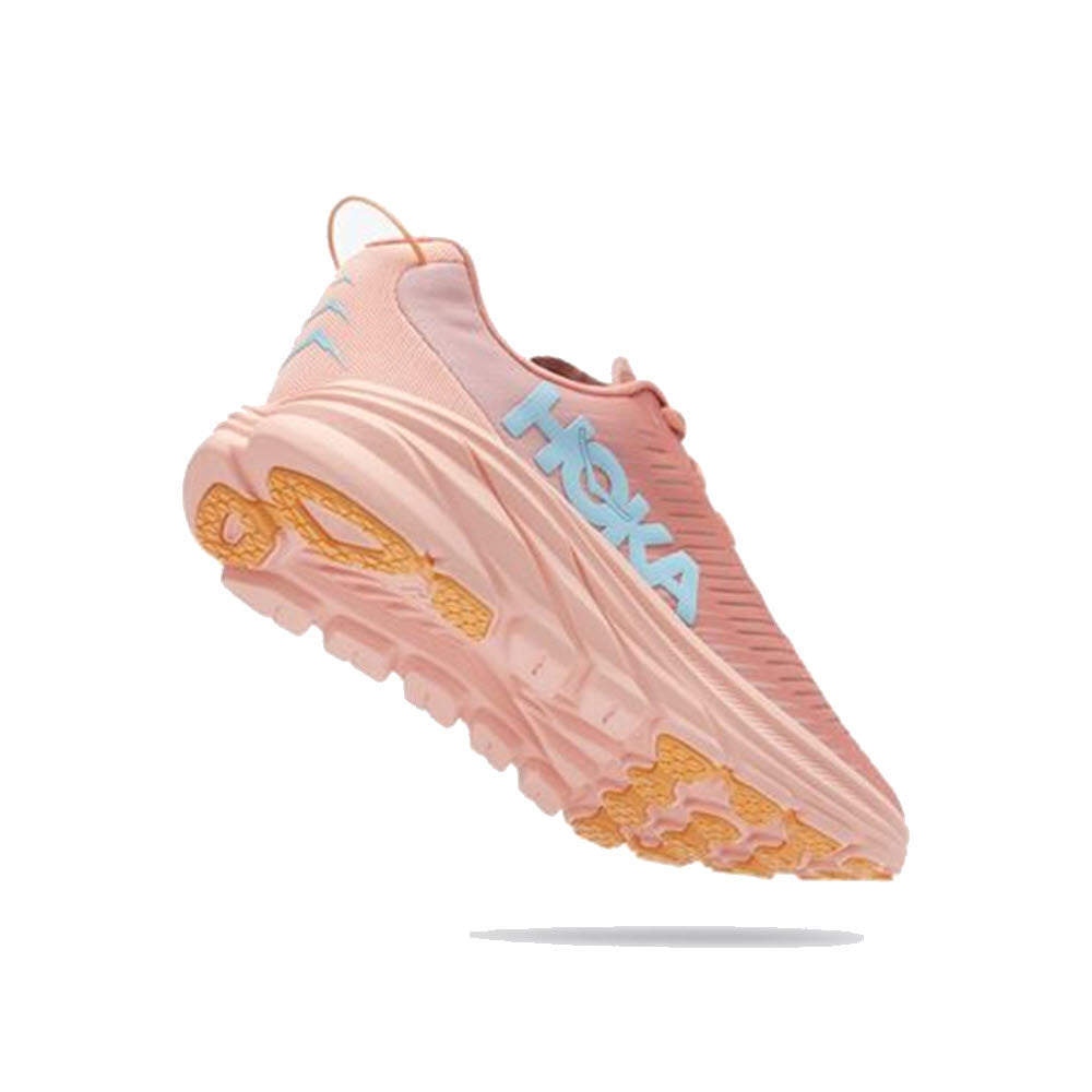 A single HOKA ONE ONE RINCON 3 SHELL CORAL/PEACH PARFAIT - WOMENS athletic shoe with the Hoka brand logo displayed on the side; it appears to be floating against a white background, featuring a vented-mesh upper.