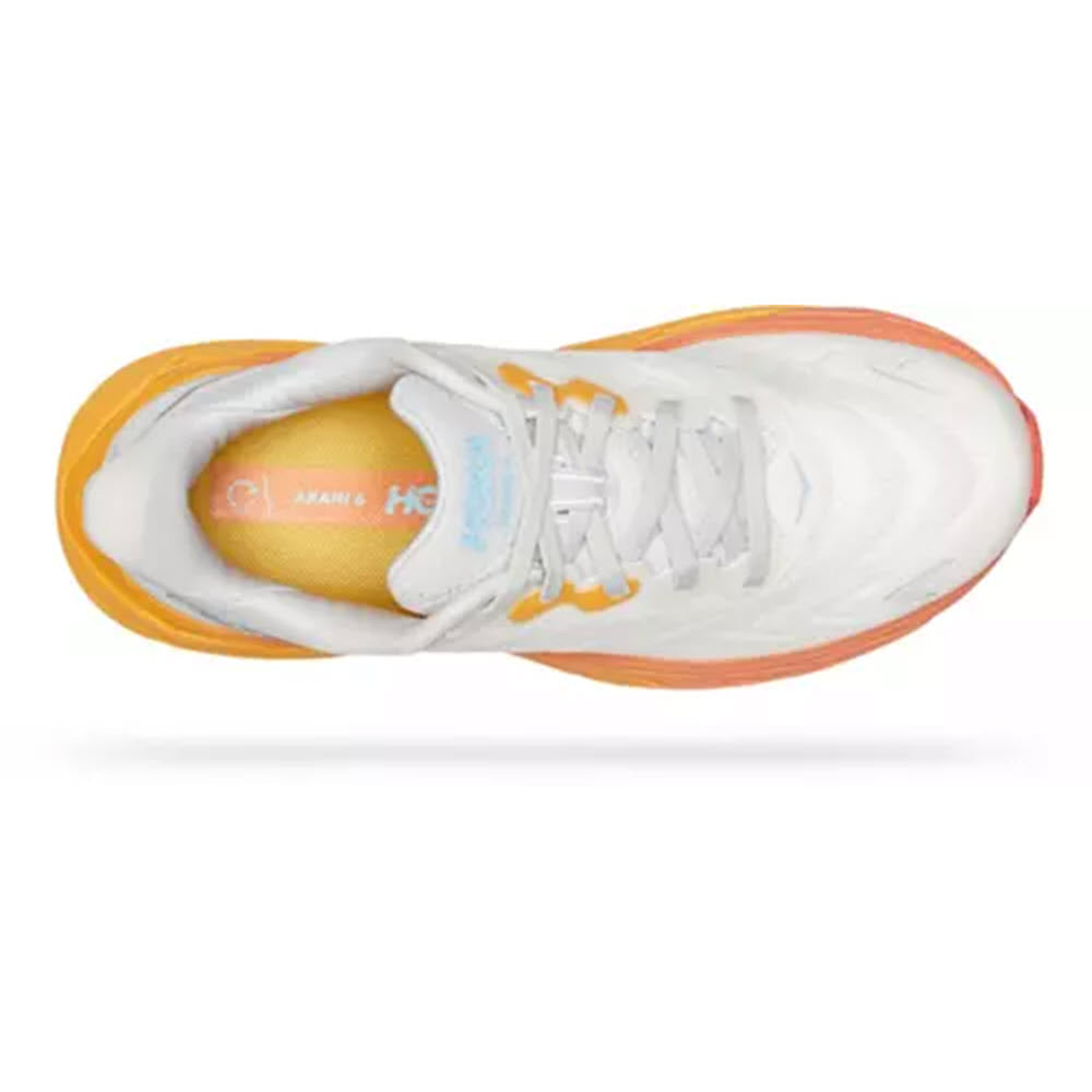 Top view of a lightweight, white Hoka Arahi 6 Nimbus Cloud Blanc De Blanc running shoe with orange accents and laces.