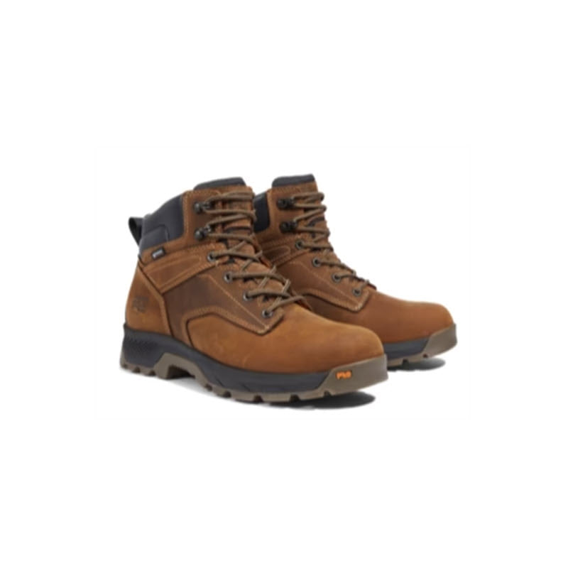 A pair of brown leather Timberland Titan EV 6&quot; WP soft toe Earth work boots with black rubber soles on a white background.
