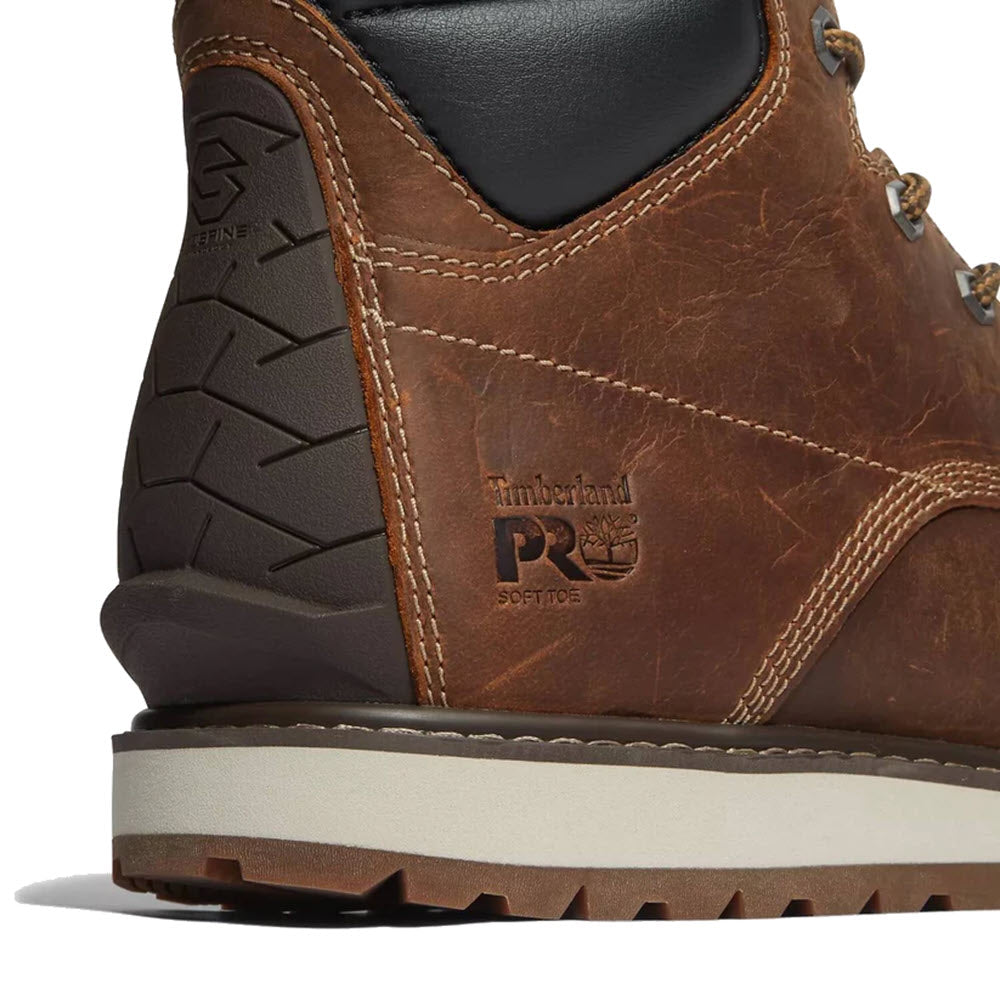 Close-up of a brown Timberland Irvine Wedge 6&quot; Soft Toe industrial boot focusing on the full-grain leather texture and embossed logo with a visible soft toe label.
