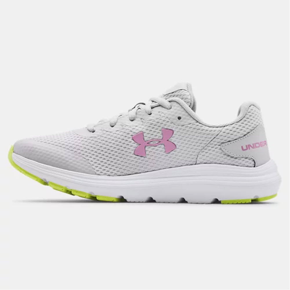 Side view of a gray and white Under Armour Surge 2 GS MOD GREY - KIDS running shoe with pink logo and neon green accents, featuring lightweight breathable mesh.