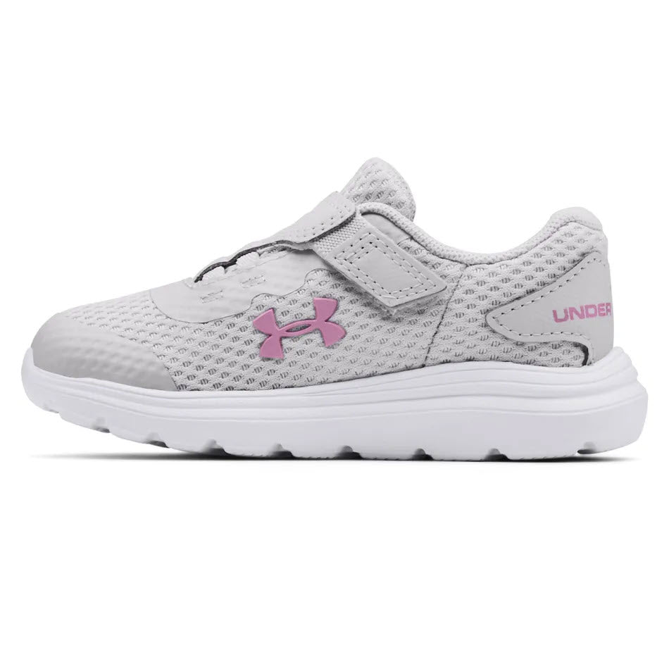 A breathable mesh upper UNDER ARMOUR SURGE 2 AC MOD GREY toddler athletic shoes with a velcro strap and pink logo.
