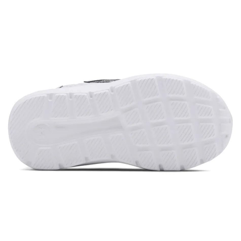 Infant athletic shoes with a white rubber sole of an UNDER ARMOUR SURGE 2 AC MOD GREY - TODDLERS shoe with tread pattern.