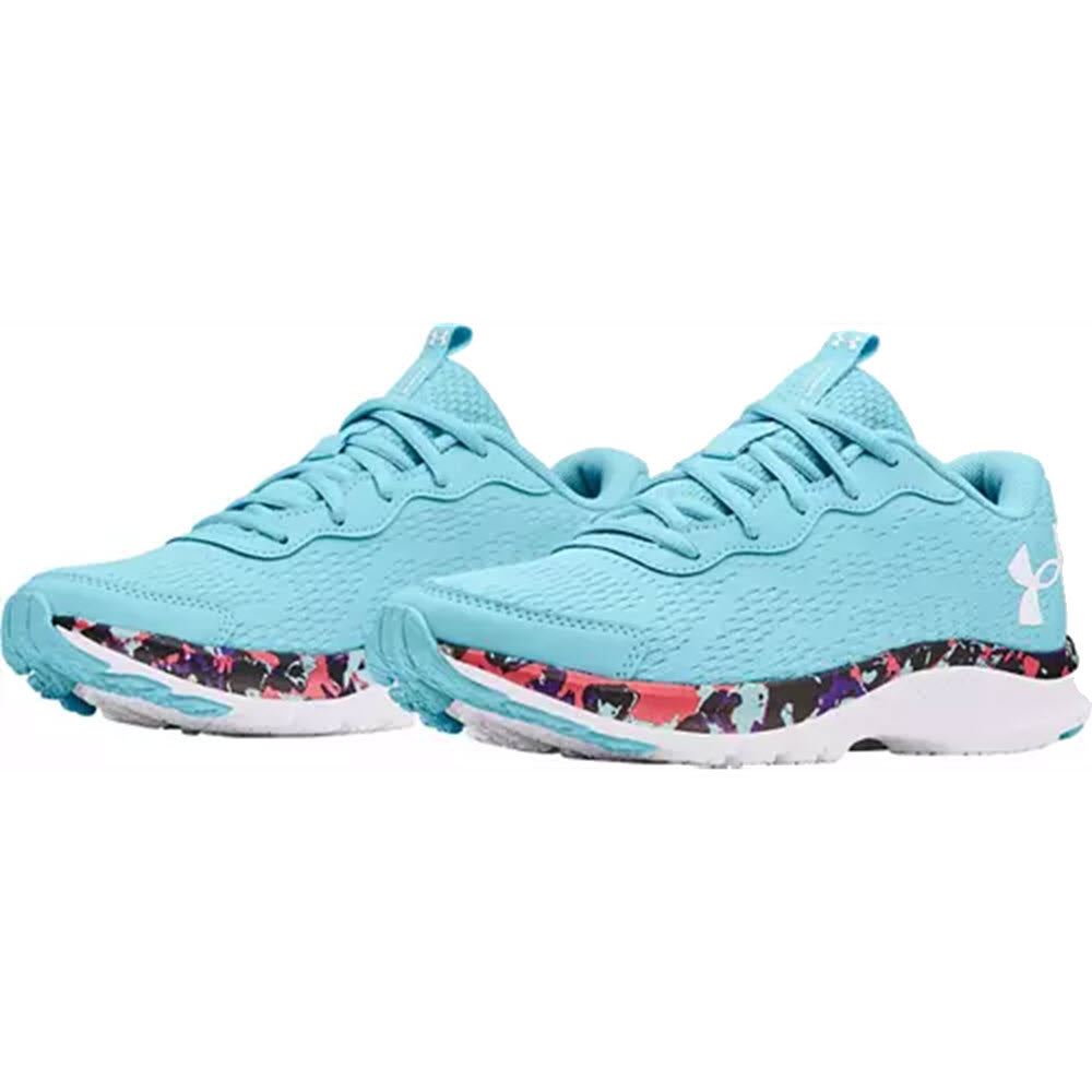 A pair of light blue Under Armour Charged Bandit 7 running shoes with a splash of colorful pattern on the outsole.