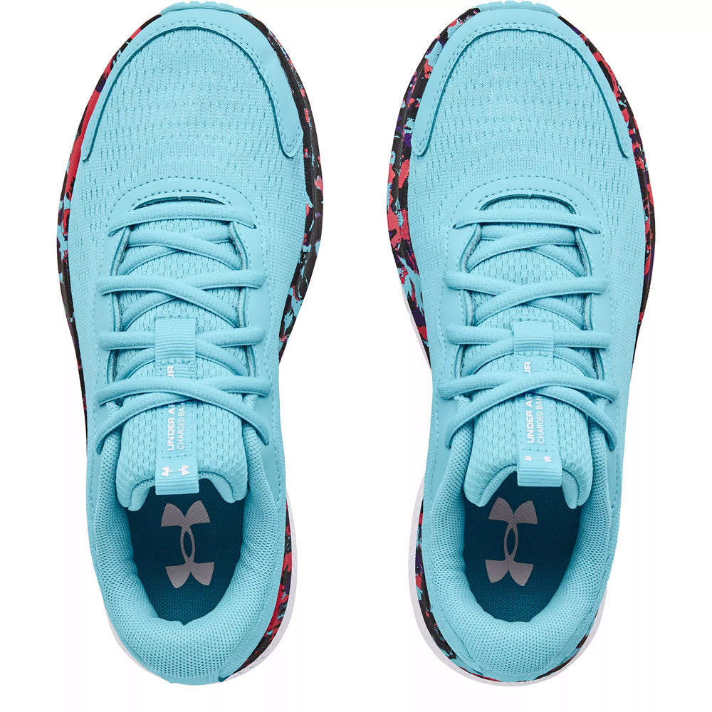 A pair of Under Armour Charged Bandit 7 Sky Blue athletic shoes with patterned soles viewed from above.